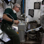 Astronaut Mark Vande Hei works on an advanced new toilet